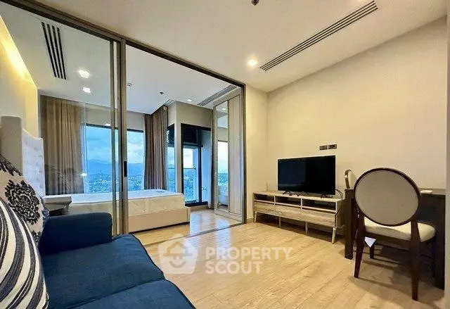 Modern living room with open layout and scenic view, featuring stylish furniture and natural light.