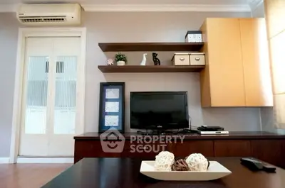 Modern living room with sleek TV setup and stylish shelving