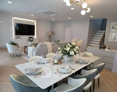 Luxurious open-plan living room with elegant dining area and modern decor