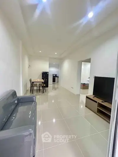 Spacious modern living room with sleek furniture and open layout, perfect for contemporary living.