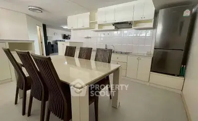 Spacious kitchen with dining area and modern appliances in a bright, open layout.