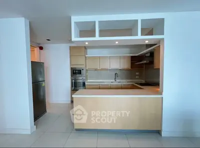 Modern kitchen with sleek cabinetry and built-in appliances in open layout.
