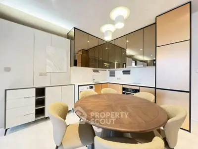 Modern kitchen with round dining table and stylish cabinetry