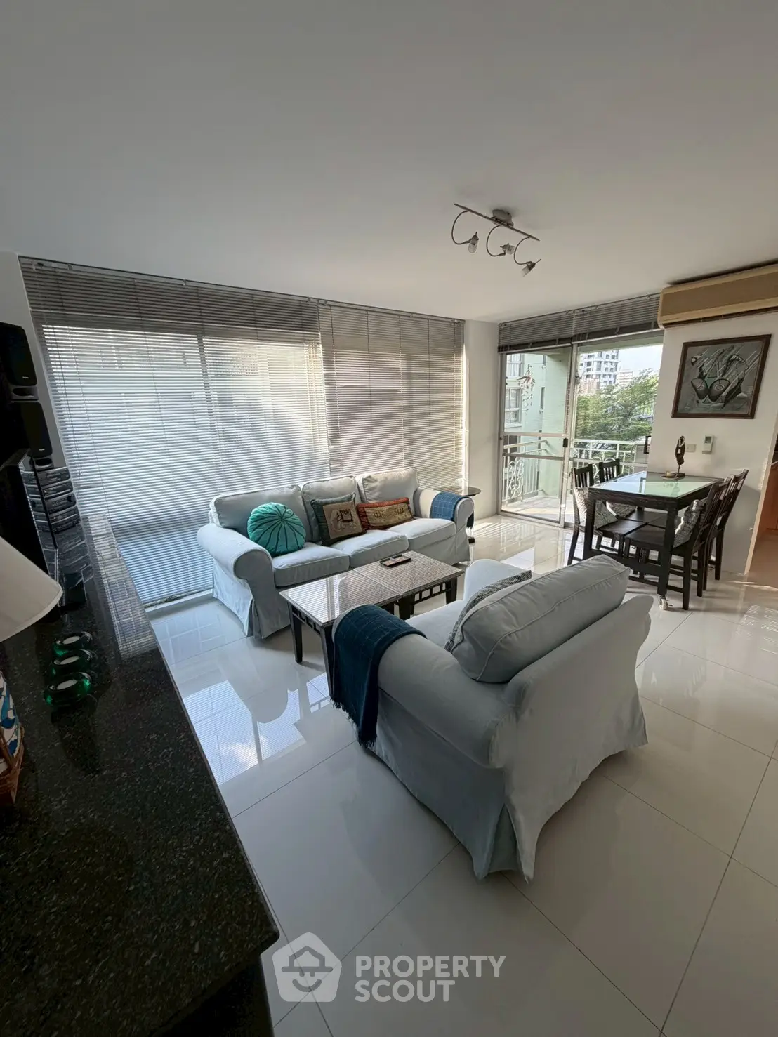 Spacious living room with modern decor and large windows offering natural light.