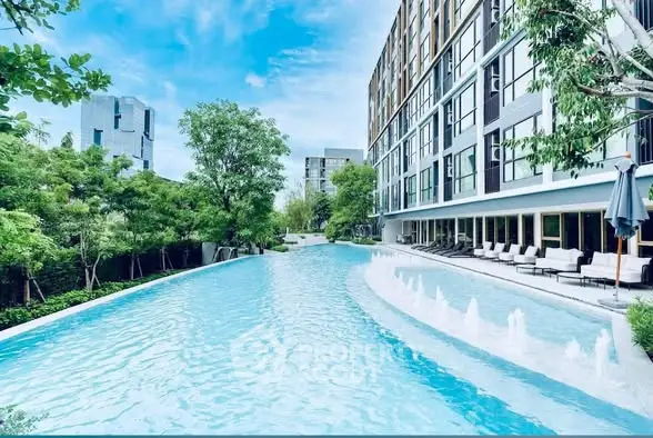 Luxurious apartment complex with stunning pool and modern architecture.