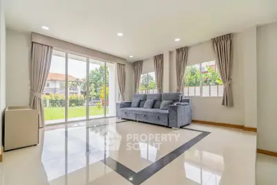Spacious living room with large windows and garden view