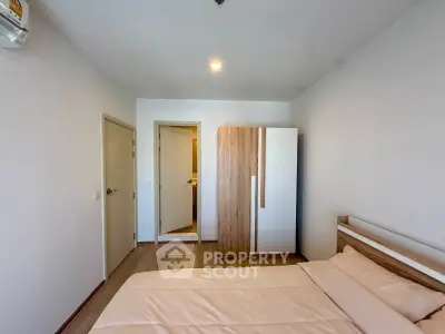 Modern bedroom with minimalist design and wooden furniture in a cozy apartment.