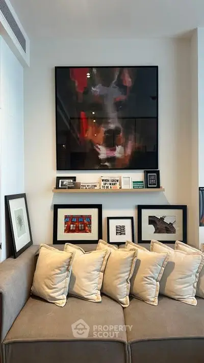 Stylish living room with modern art and cozy sofa, perfect for relaxation.