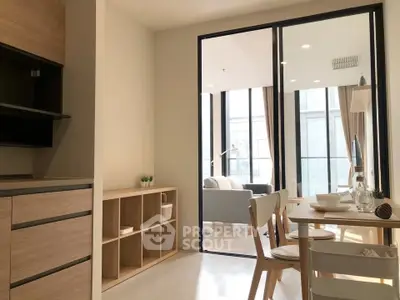 Modern open-plan kitchen and dining area with natural light and stylish decor.
