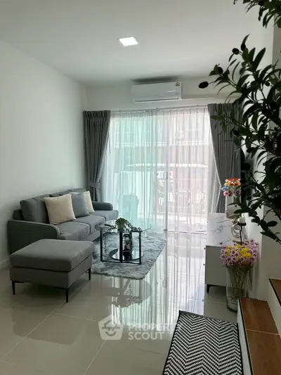 Modern living room with sleek furniture and natural light, perfect for urban living.