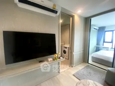 Modern apartment interior with TV, air conditioning, and washing machine in a cozy living space.