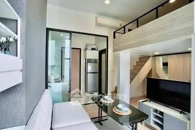 Modern loft-style living room with mezzanine, sleek furniture, and open kitchen layout.