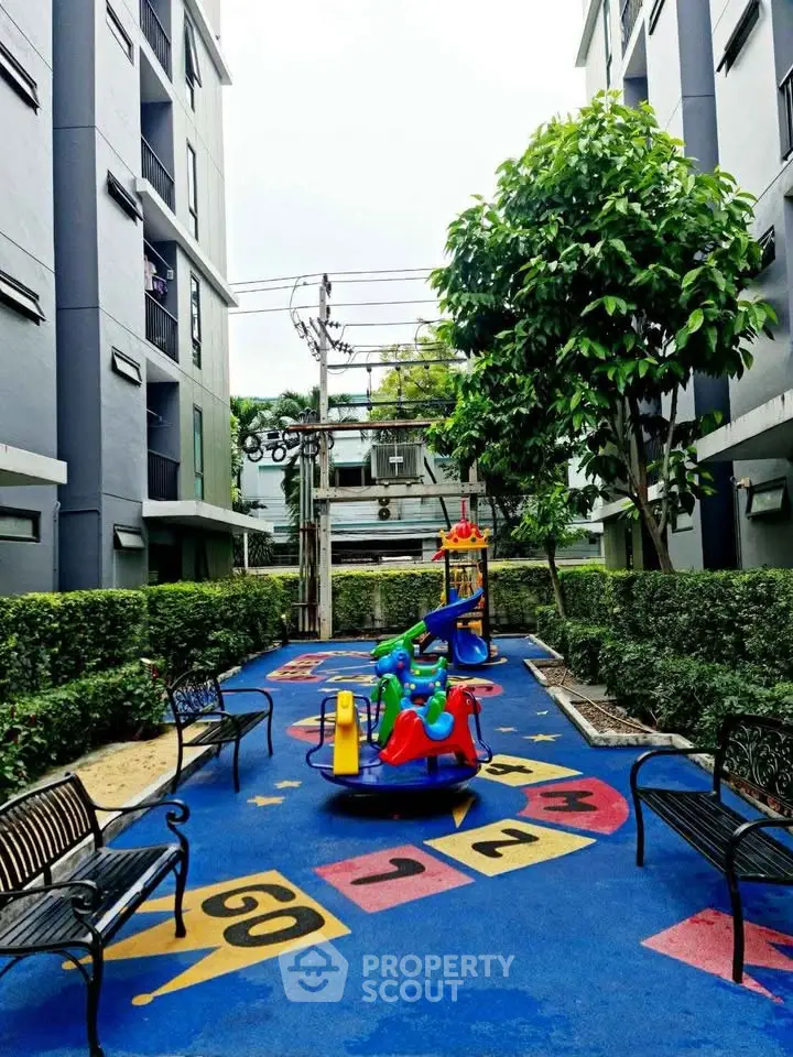 Charming residential playground with colorful equipment and lush greenery, perfect for family-friendly living.