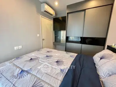 Modern bedroom with stylish bedding and sleek wardrobe design