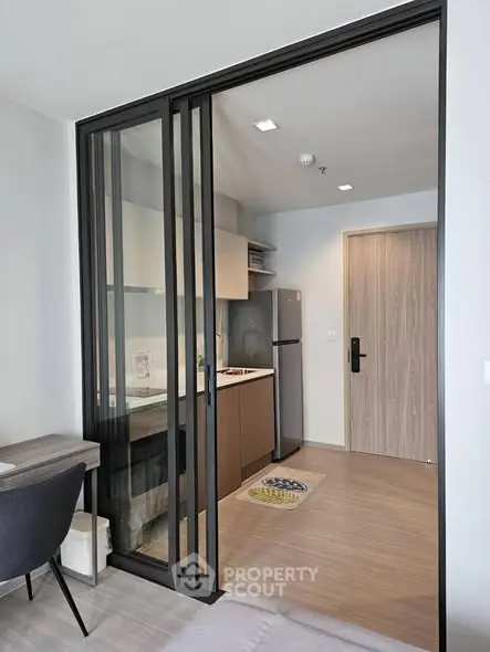 Modern apartment with sleek kitchen and sliding glass doors