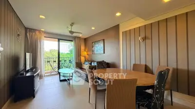 Stylish living room with balcony view, modern furniture, and elegant decor in a cozy apartment.