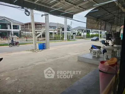 Street view of modern residential area with houses and motorbikes, showcasing suburban lifestyle.