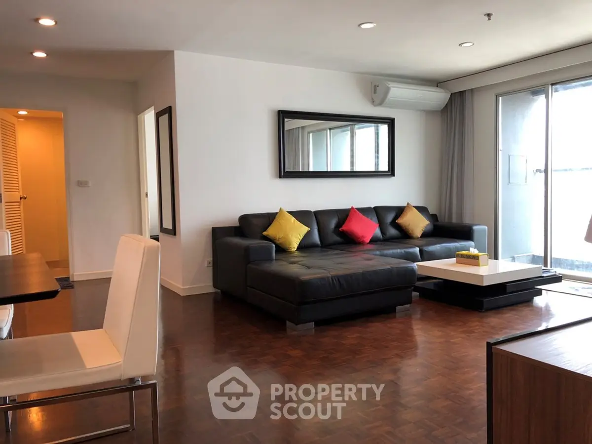 Spacious modern living room with stylish decor and large windows for natural light.