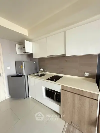 Modern kitchen with sleek cabinetry and built-in appliances in a stylish apartment.