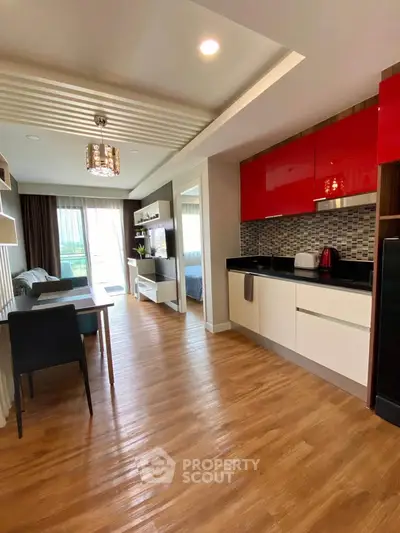 Modern open-plan living room and kitchen with stylish decor and wooden flooring