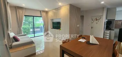 Modern living room with large window and stylish dining area in a contemporary home.