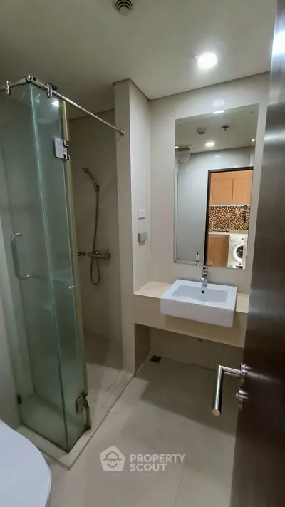 Modern bathroom with glass shower and sleek sink design