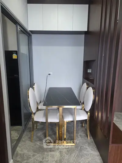 Modern dining area with elegant chairs and sleek table in a compact space