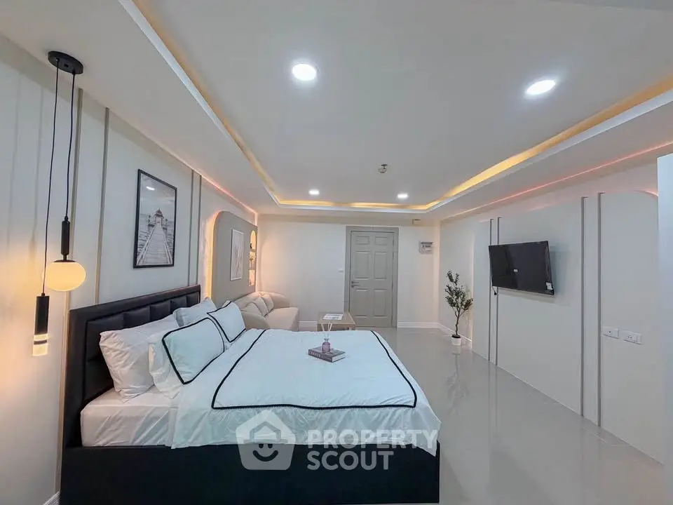Spacious modern bedroom with elegant decor and ambient lighting