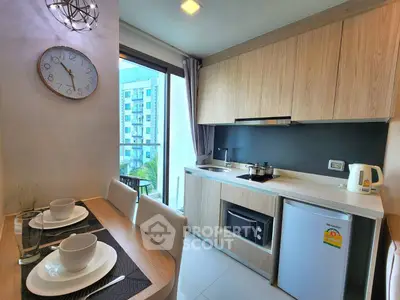 Modern kitchen with wooden cabinets and dining area in a bright apartment