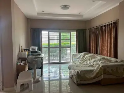 Spacious living room with large windows and cozy seating area