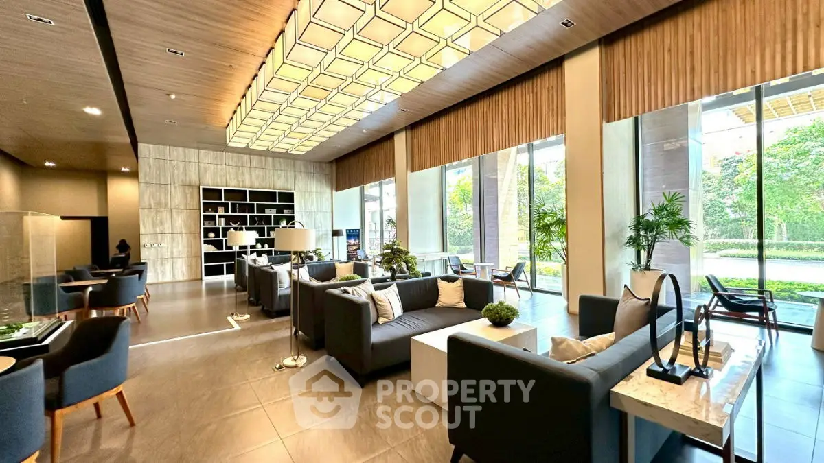 Luxurious modern living room with elegant decor and large windows offering garden views.