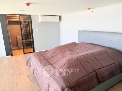 Spacious bedroom with modern design and walk-in closet in a luxury apartment.