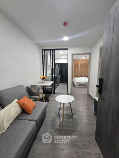 Modern apartment interior with cozy living room and stylish bedroom, featuring sleek furniture and contemporary design.