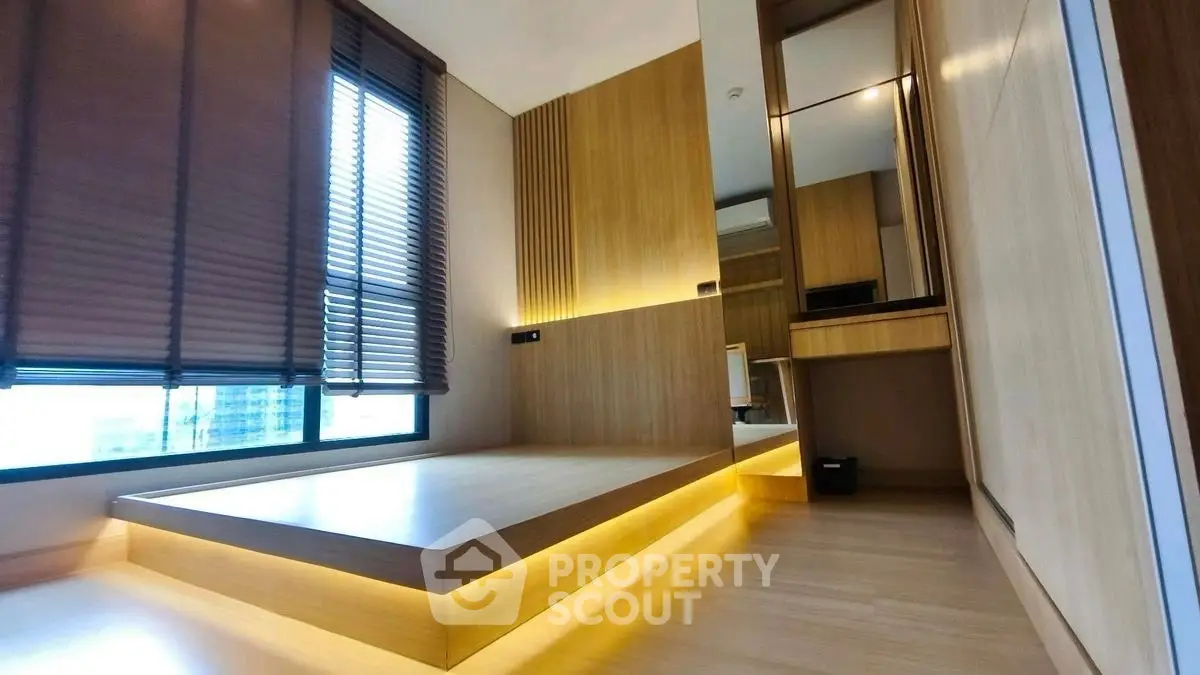Modern minimalist bedroom with platform bed and ambient lighting