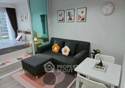 Modern living room with stylish decor and cozy seating in a contemporary apartment.