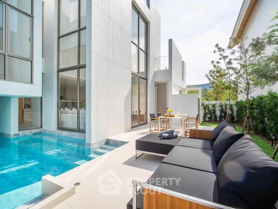 Luxurious modern villa with private pool and stylish outdoor seating area, perfect for relaxation and entertainment.
