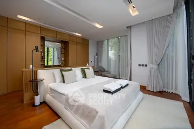 Luxurious modern bedroom with elegant decor and large windows offering natural light.