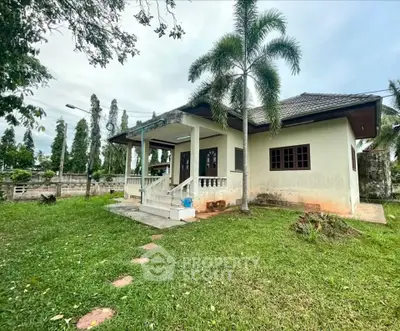Charming single-story home with lush green lawn and inviting front porch in a serene neighborhood.