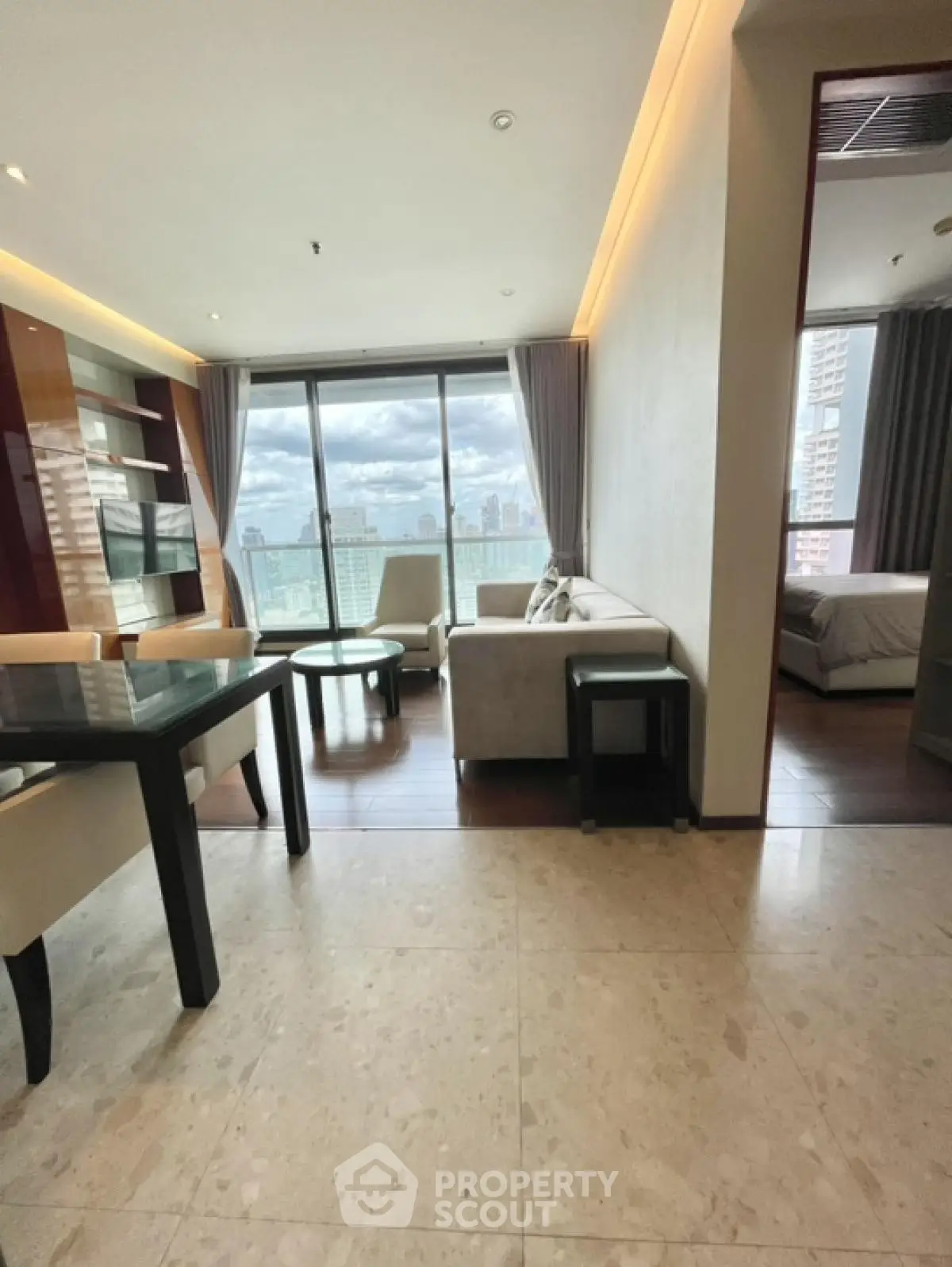 Luxurious high-rise living room with stunning city view and elegant furnishings.