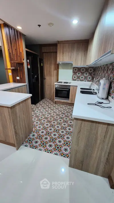 Modern kitchen with stylish patterned tiles and wooden cabinetry, featuring sleek appliances and ample counter space.