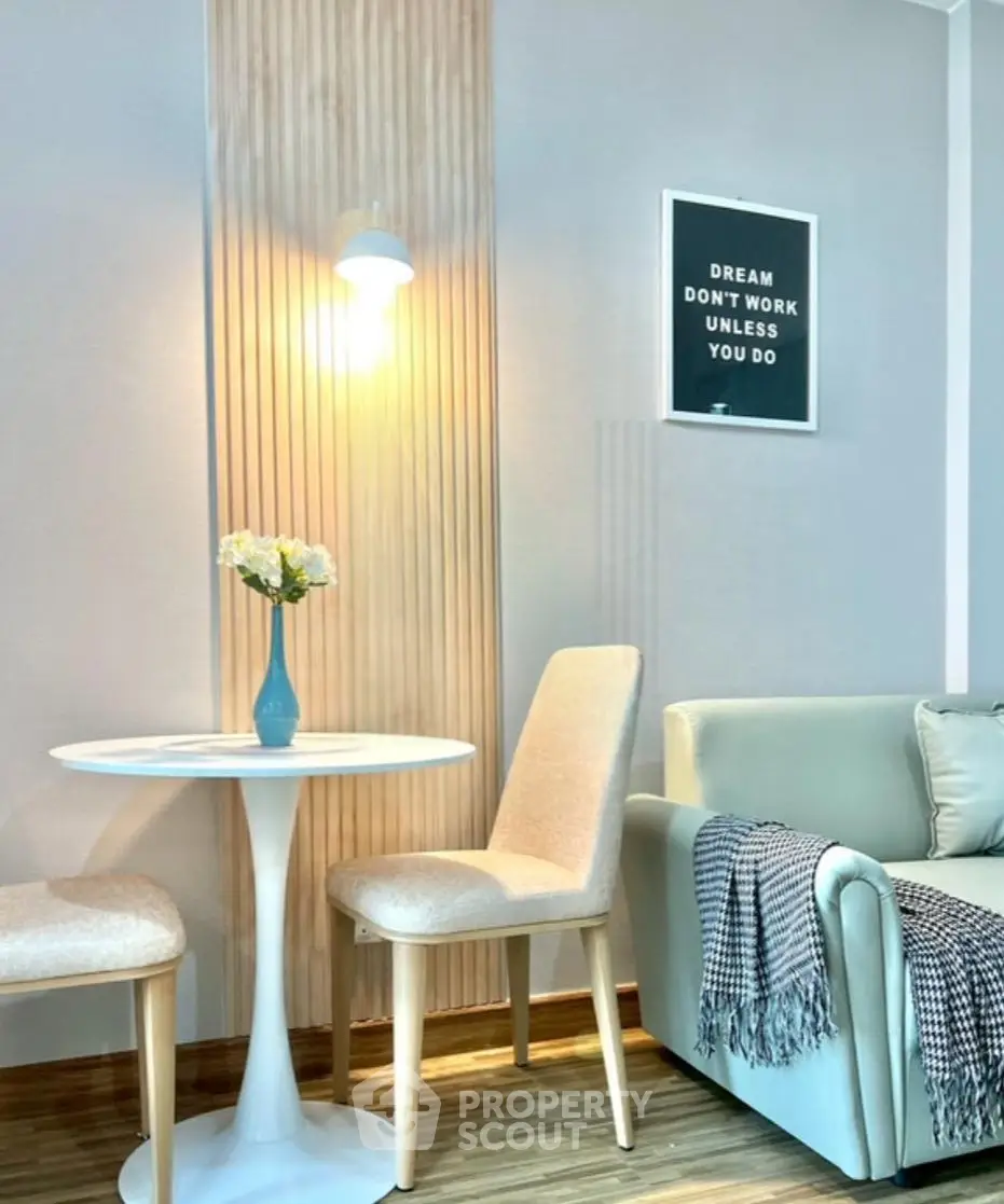 Chic living room with modern decor, cozy seating, and motivational wall art.
