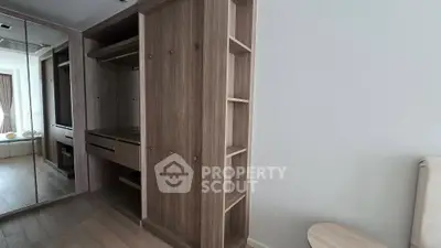 Spacious modern bedroom with built-in wooden wardrobe and mirrored sliding doors