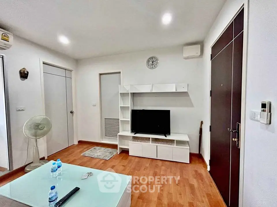 Modern living room with wooden flooring and sleek furniture