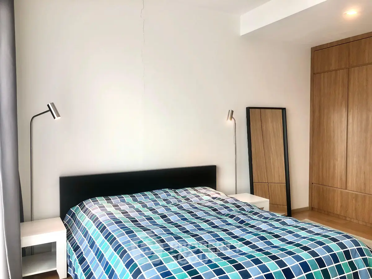 Modern bedroom with stylish decor and ample natural light