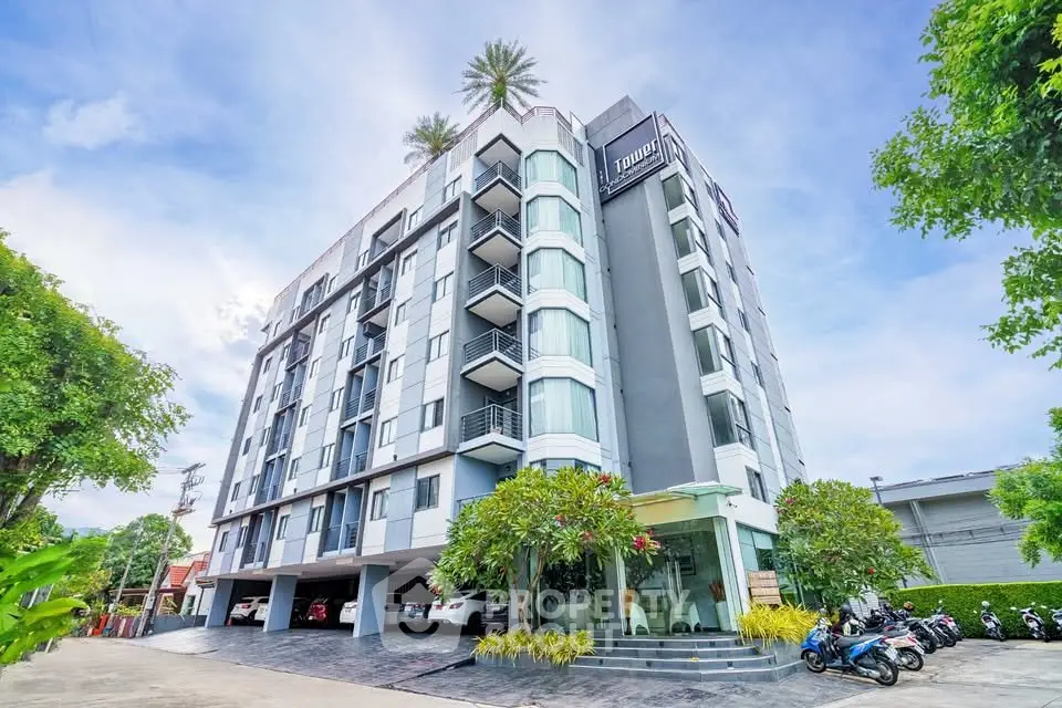 Modern apartment building with lush landscaping and clear blue sky