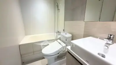 Modern bathroom with sleek fixtures and bathtub in contemporary apartment.