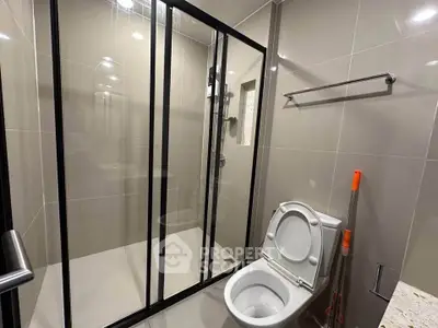 Modern bathroom with glass shower enclosure and sleek fixtures