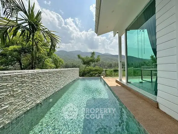 Luxurious modern home with stunning infinity pool and mountain views, perfect for serene living.
