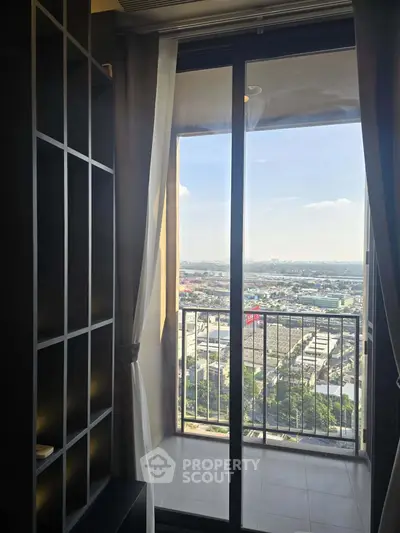 Stunning high-rise balcony view with expansive cityscape panorama and modern sliding glass doors.