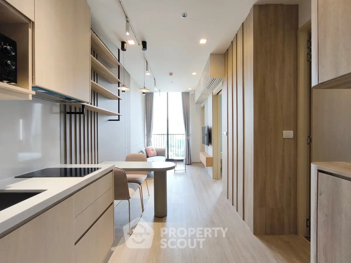 Modern open-plan kitchen and living area with sleek design and natural light